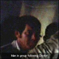 Man in group following Doctor